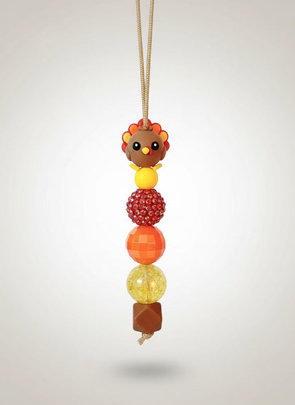 Mommie Peas Creations Thanksgiving Turkey beaded lanyard with red, orange, and yellow beads and a 3D turkey charm.