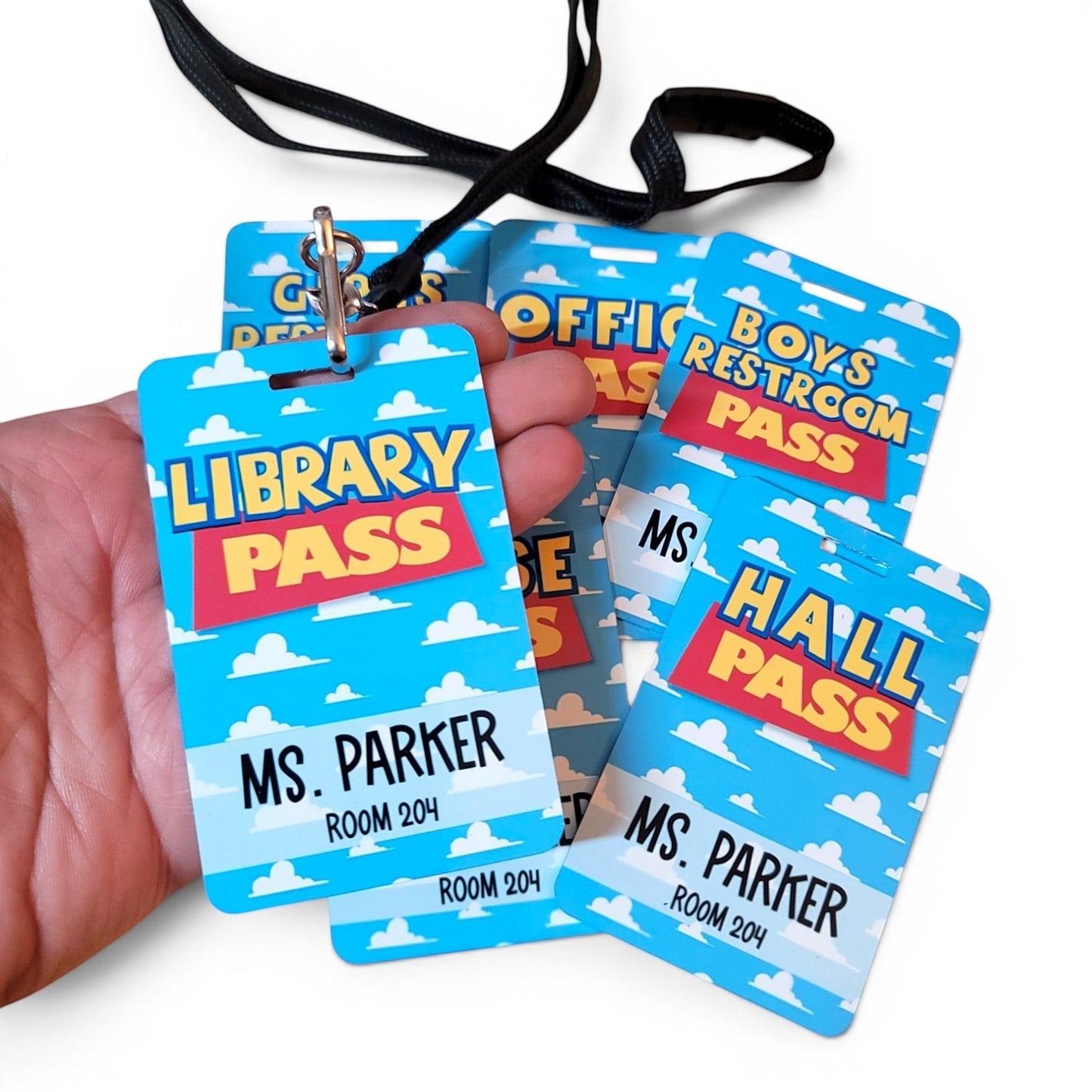 Mommie Peas Creations personalized metal classroom hall passes with a blue sky and cloud Toy Story inspired design.
