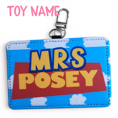 Mommie Peas Creations personalized ID holder with Toy Story inspired cloudy sky background and yellow name text.