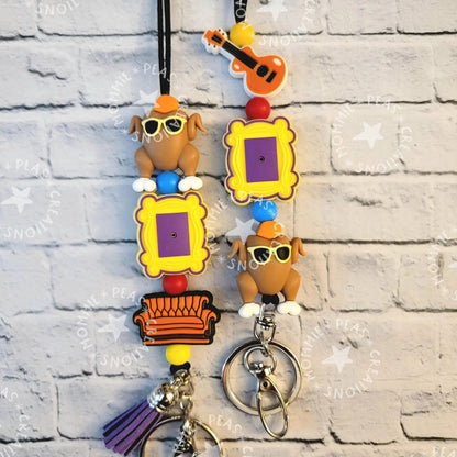 Mommie Peas Creations turkey lanyard with Friends-themed charms: Central Perk couch, picture frames, and sunglasses-wearing turkeys.