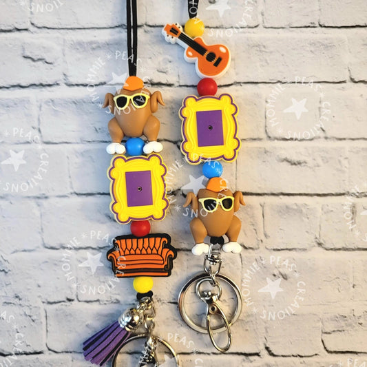 Mommie Peas Creations turkey lanyard with Friends-themed charms: Central Perk couch, picture frames, and sunglasses-wearing turkeys.