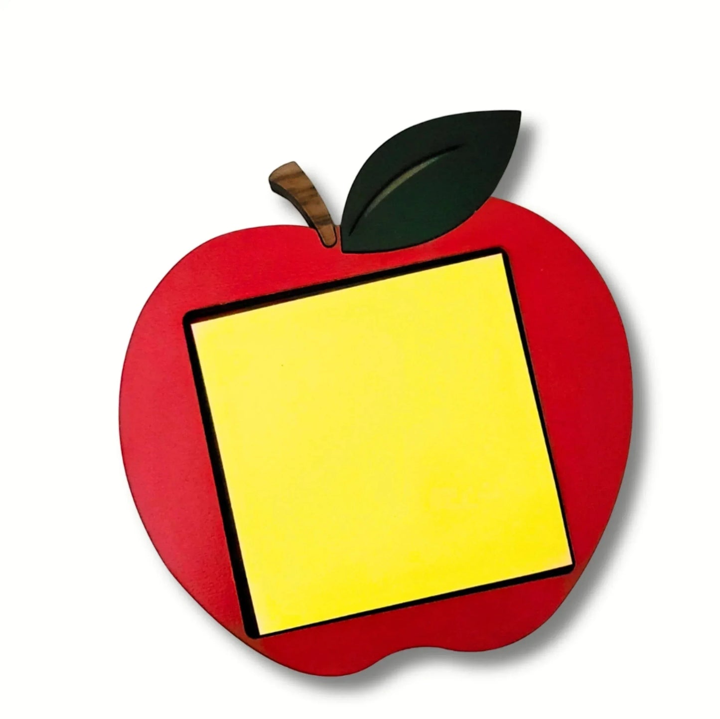 Mommie Peas Creations red apple sticky note holder made of laser cut wood with a yellow sticky note. Features a green leaf and brown stem.
