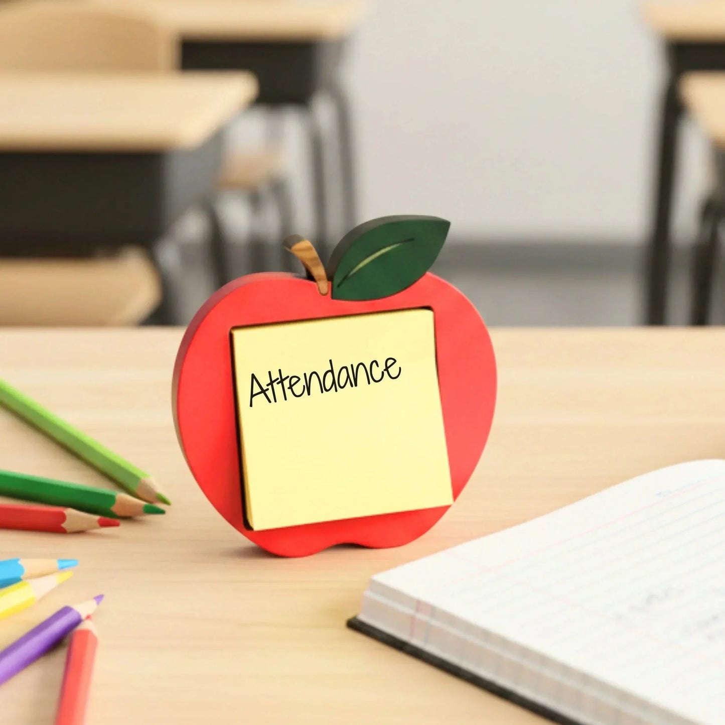 Mommie Peas Creations red apple sticky note holder made of laser cut wood, with a yellow sticky note that says "Attendance".