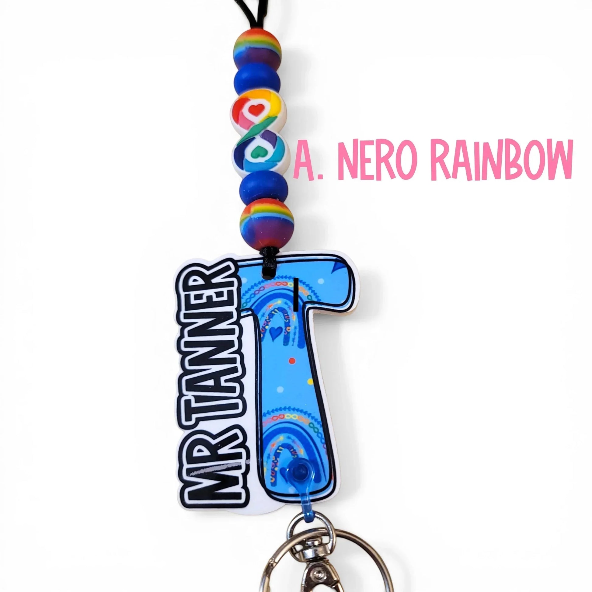 Mommie Peas Creations blue acrylic letter T lanyard for Mr Tanner with rainbow and heart designs, beaded cord.