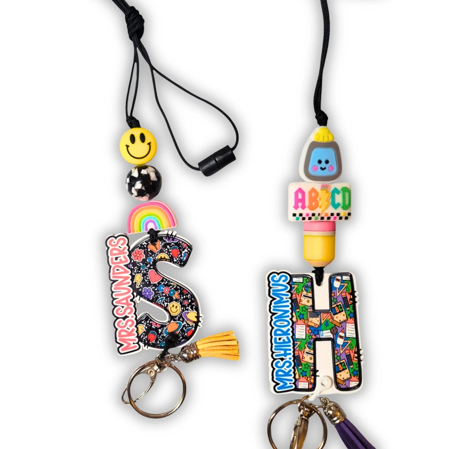 Mommie Peas Creations custom teacher lanyard with colorful school supplies, smiley face, rainbow, and personalized initial.