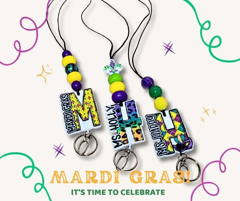 Mardi Gras themed lanyards with purple, green, and gold beads and custom initial charms. Mommie Peas Creations.