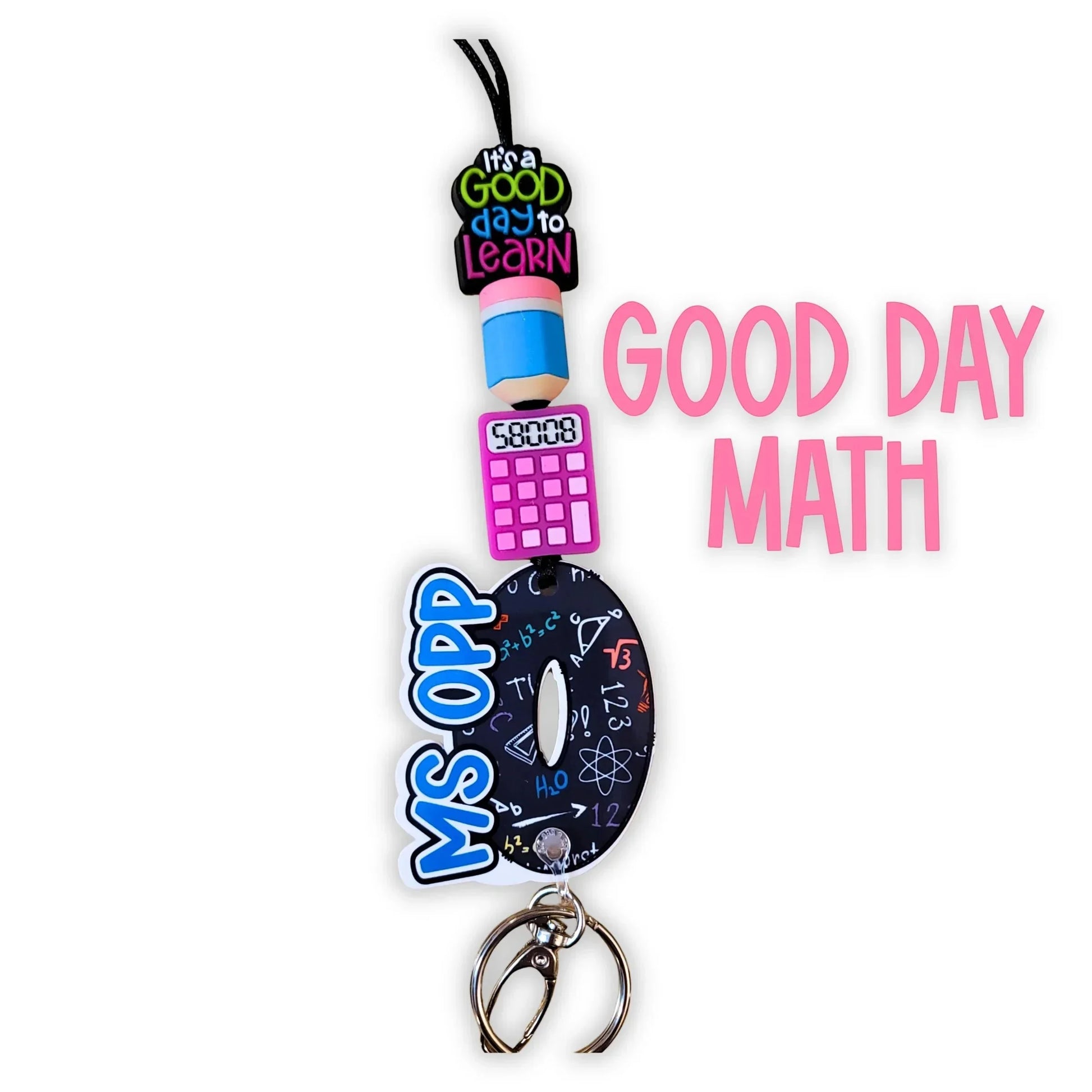 Mommie Peas Creations Math Teacher Lanyard with acrylic charms: 'It's a good day to learn', pencil, calculator, and a large 'D' charm with math symbols and 'MS OPP'.
