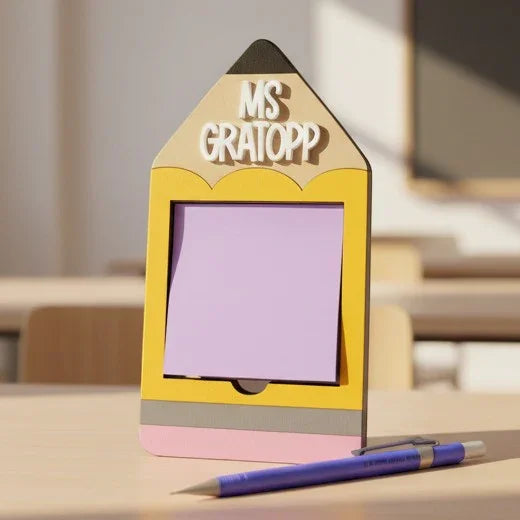 Mommie Peas Creations personalized wooden pencil Post-it note holder with "MS GRATOPP" text, holding a lavender sticky note.