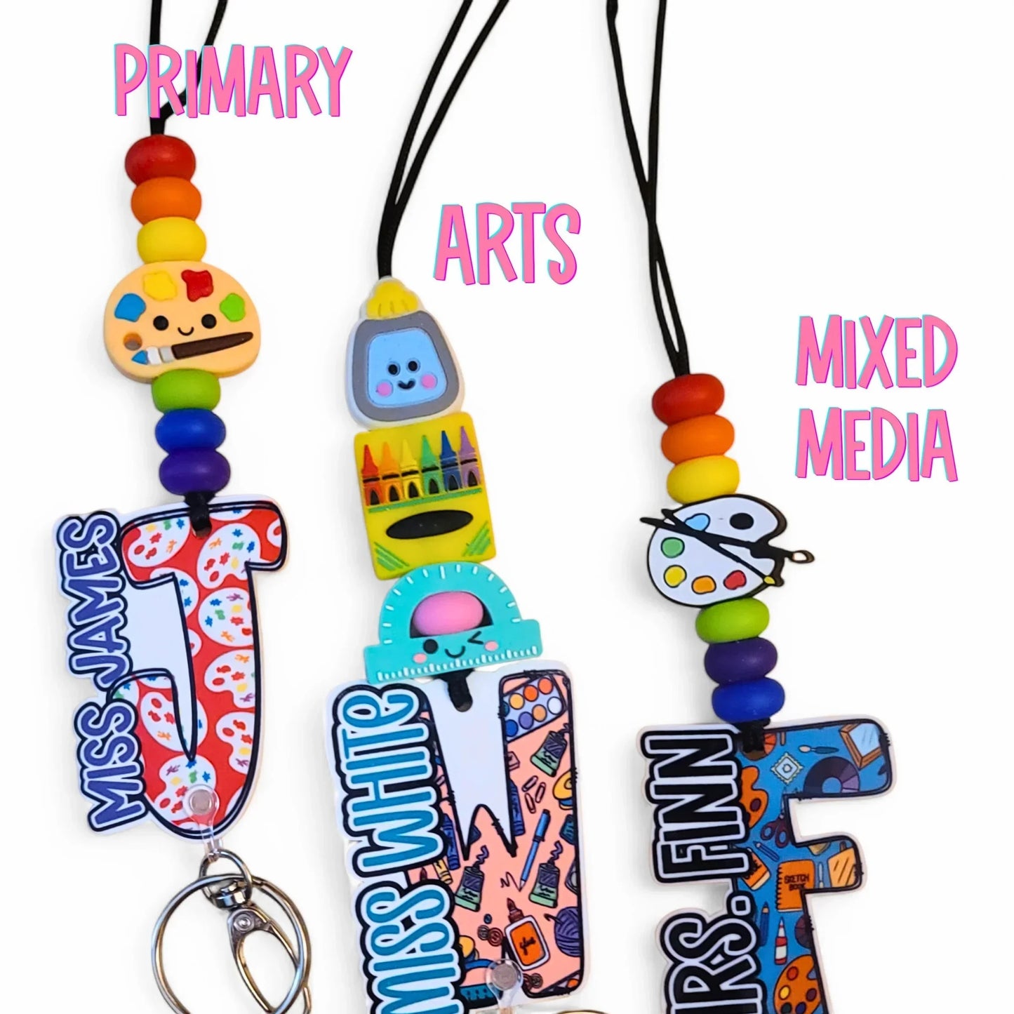 Mommie Peas Creations personalized teacher lanyard with silicone beads, acrylic charm, and custom letter. Features school-themed designs like paint palettes and rulers.
