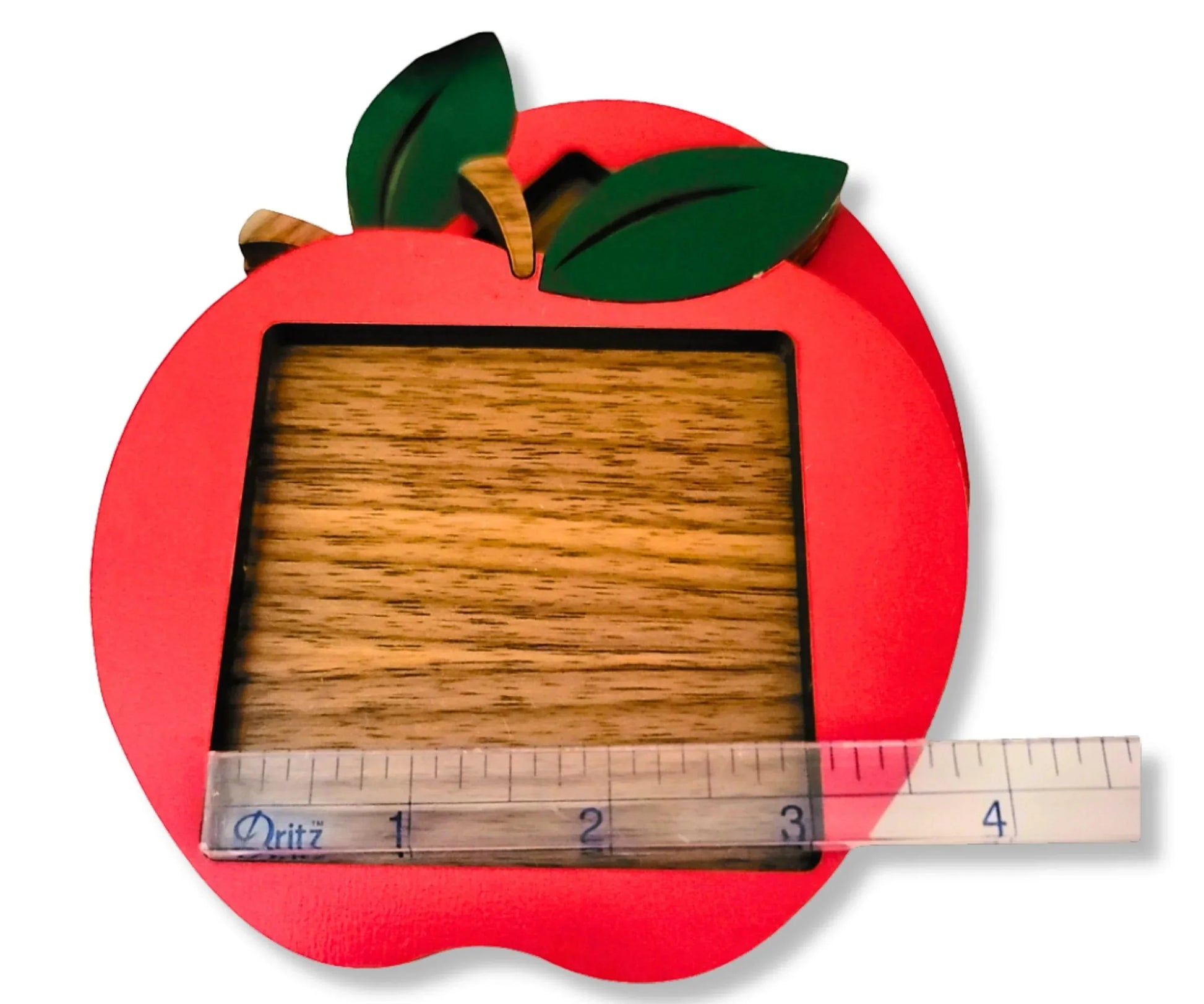 Mommie Peas Creations red apple sticky note holder made from laser cut wood with green leaves and a wooden stem.