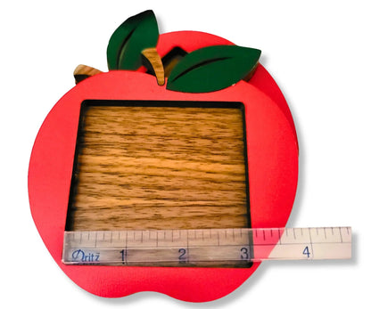 Mommie Peas Creations red apple sticky note holder made from laser cut wood with green leaves and a wooden stem.