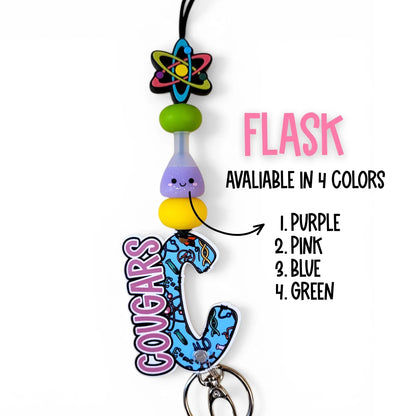 Mommie Peas Creations science lanyard with atom charm, silicone beads, and a blue 'Cougars' acrylic charm featuring science icons. Available in 4 colors.