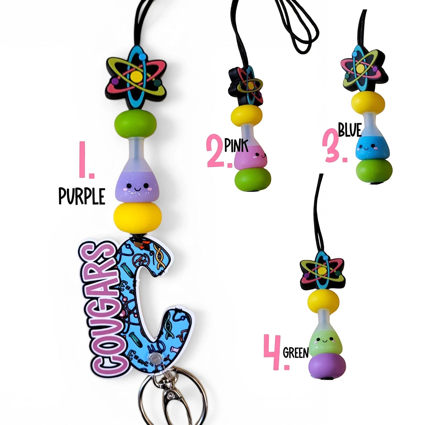 Mommie Peas Creations science lanyard with atom charm, silicone beads in purple, yellow, and green, and a personalized 'Cougars' acrylic charm.
