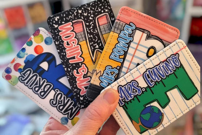Mommie Peas Creations vertical ID badge holders in PU leather with teacher-themed designs like pencils, notebooks, and globes.