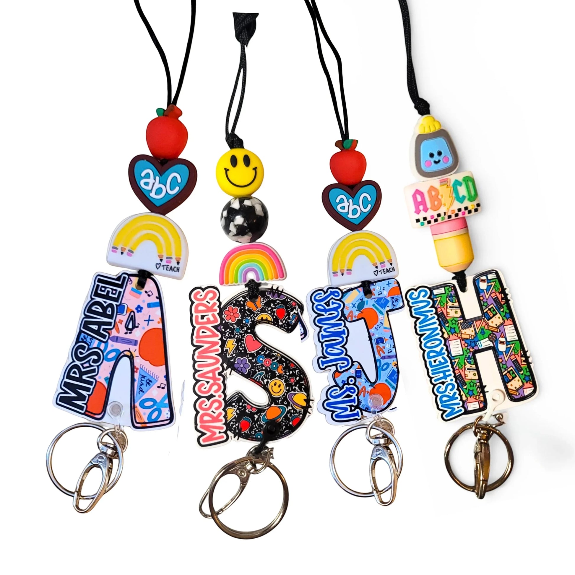 Mommie Peas Creations custom teacher lanyard with colorful beads, ABC checkers motif, and personalized name on acrylic initial.