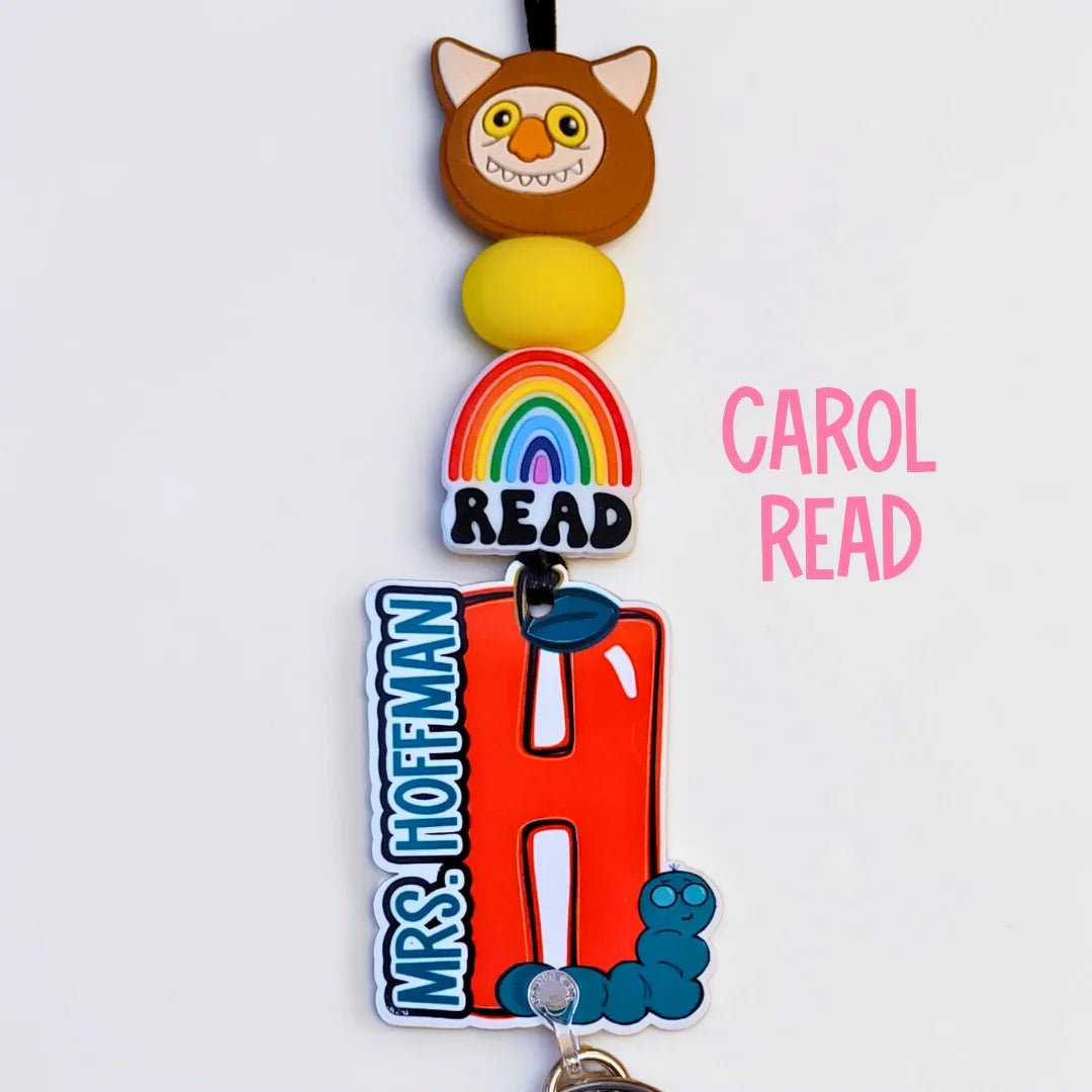 Handmade colorful teacher lanyard with owl, rainbow, large red H charm and Mrs. Hoffman text.