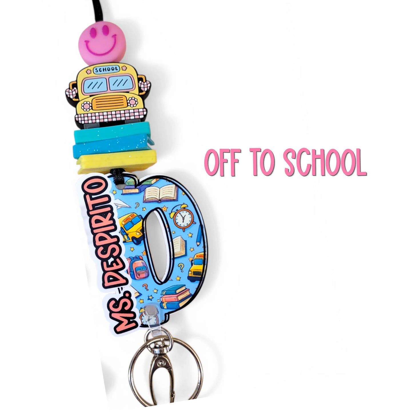 Colorful handmade teacher lanyard with school bus, books, and smiley charm, personalized gift