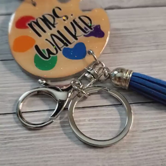 Close up video showing the glossy resin finish and vibrant rainbow beads of the personalized art palette lanyard | Id Holder for teachers | Art